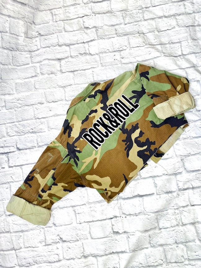 rock n roll camo jacket on a white brick background