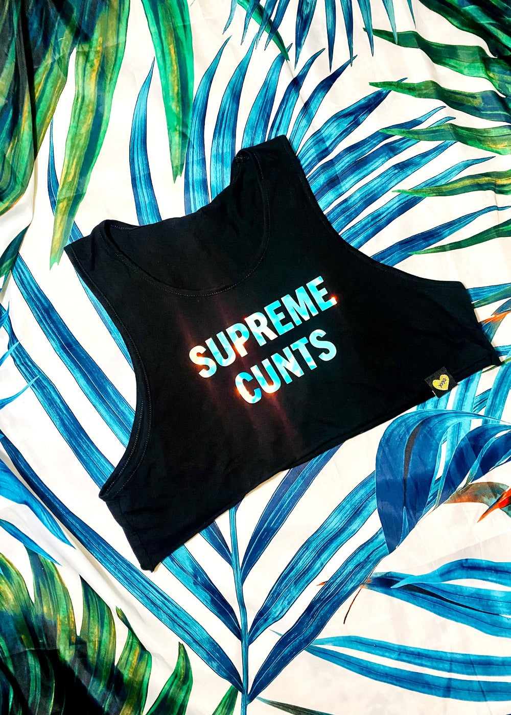 black graphic crop tank top on palm background