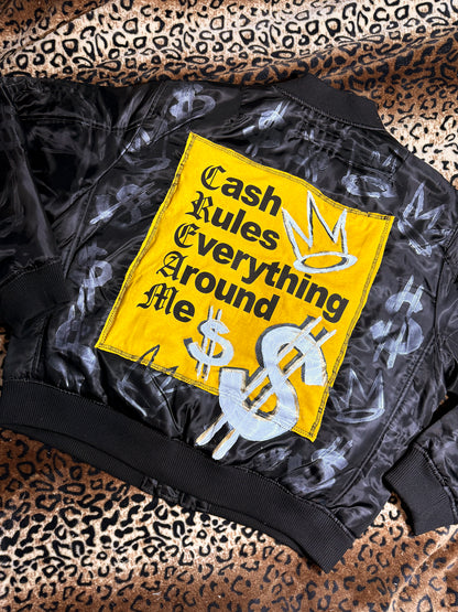 Black jacket with a yellow patch featuring text and symbols on a leopard print background