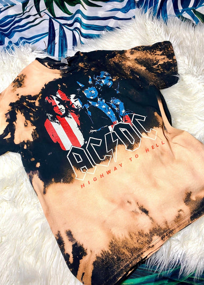 acdc band t shirt with american flag design on a white furry background close up