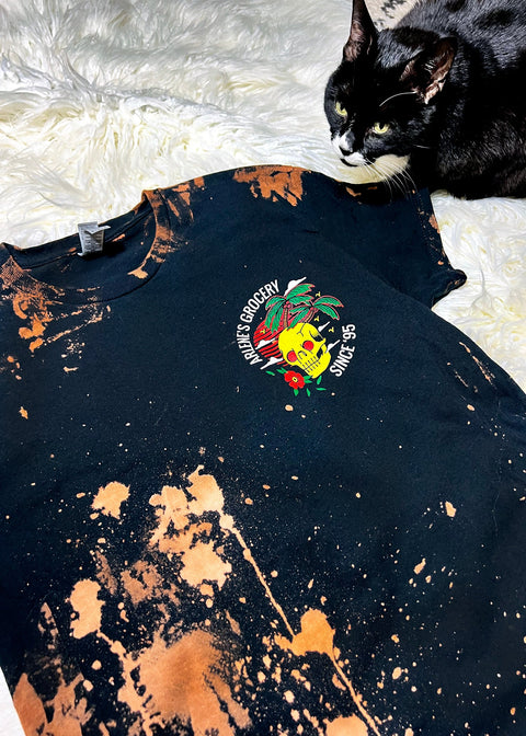 bleach dye t shirt with a black and white cat on a furry rug close up