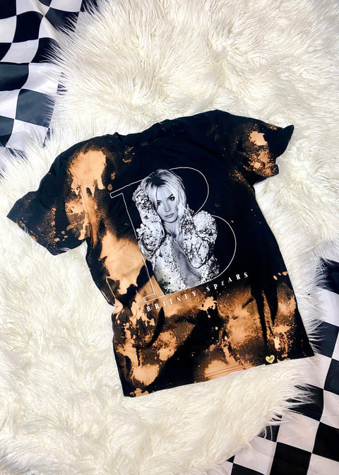 britney spears bleach dye t shirt on a white furry background full view