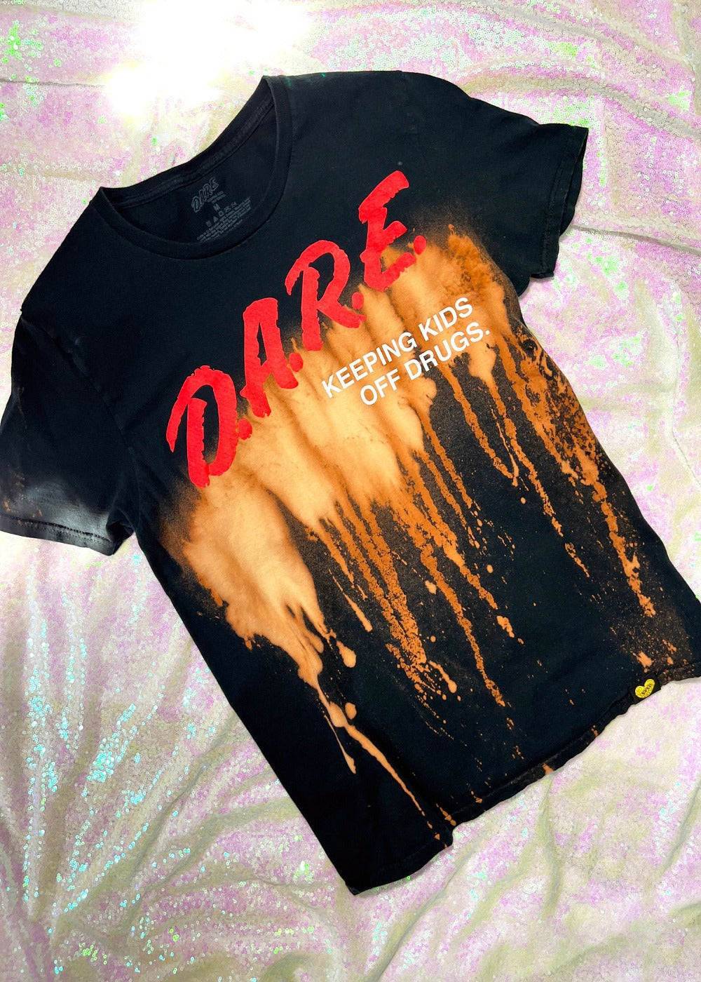 DARE bleach dye t shirt on a holo background