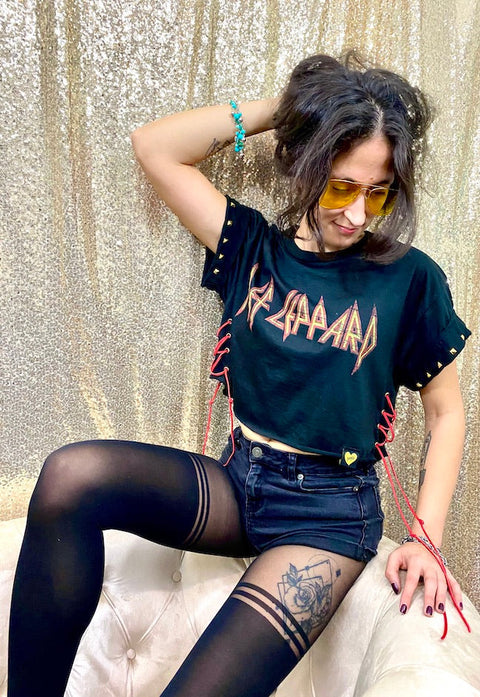 def leppard crop top on model seated in front of gold background
