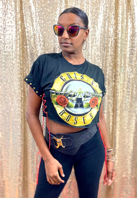 guns n roses black crop top on model with sunglasses in front of gold background side angle view