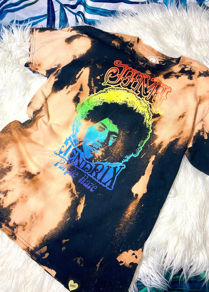 jimi hendrix black and rainbow bleach dye t shirt on a white furry and palm background close up