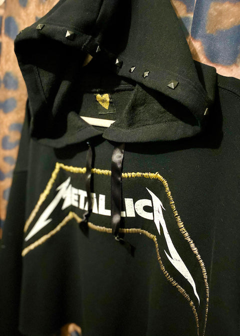 black metallica hoodie with studded hood close up on leopard print background