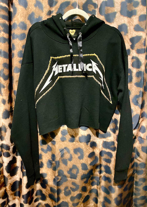 black and gold metallica hoodie on leopard print background