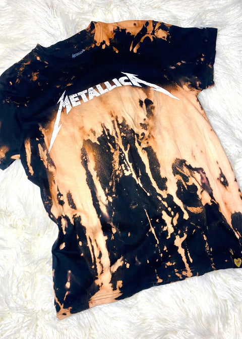 metallica bleach dye t shirt on a white furry background close up