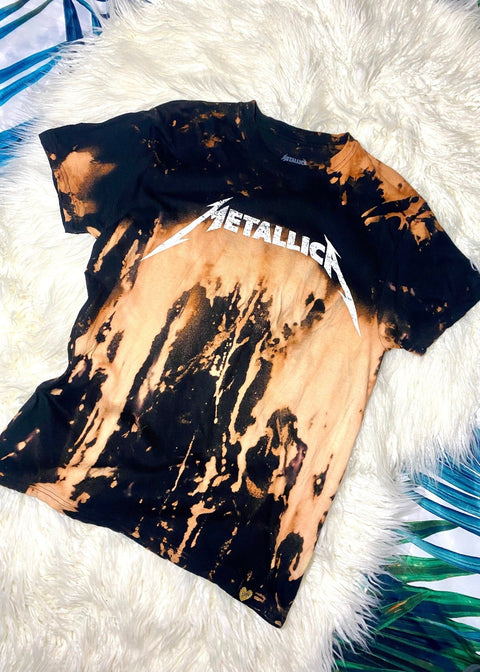 metallica bleach dye t shirt on a white furry background shot from above