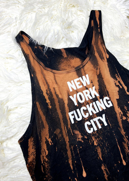 bleach dyed tank top on a white furry background angled view