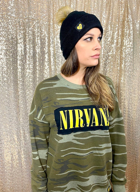 camo sweatshirt with nirvana patch on front on model wearing a black beanie