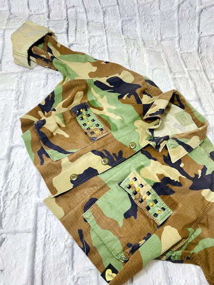 rock n roll camo jacket on a white brick background front