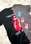 rolling stones t shirt on a white furry background angle view