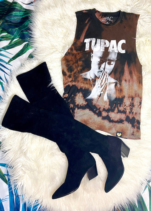 bleach dyed tupac oversized muscle tank top with thigh high suede boots on white furry rug
